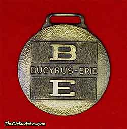 Bucyrus-Erie logo, Binder Machinery watch fob